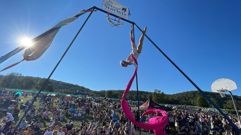 Woman on 20ft aerial rig doing silks show