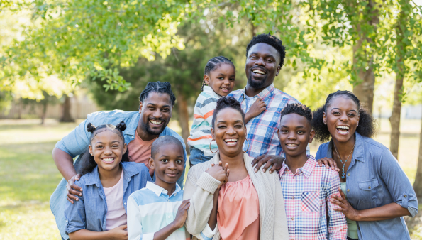 A large african american family smiling for a family portrait